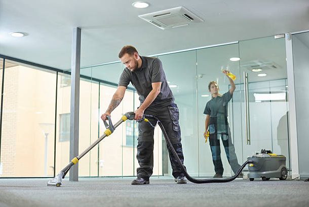Technician steam cleaning carpet with eco‑friendly equipment