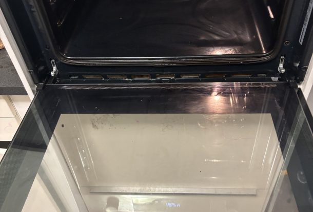 Technician deep-cleaning oven in Essex kitchen