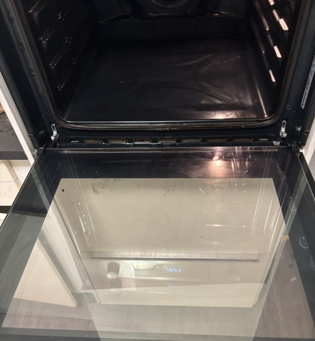 Technician deep-cleaning oven in Essex kitchen