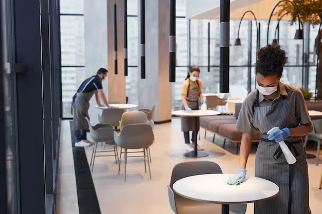 wide angle shot workers wearing masks while cleaning tables cafe interior covid safety concept copy space 236854 31359