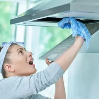 young-woman-cleaning-dirt-kitchen_470178-22562